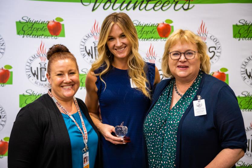 Three women pose for a photo
